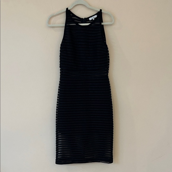 Black dress by Parker. See through at waist and below knees. Zipper in back. - Picture 1 of 6